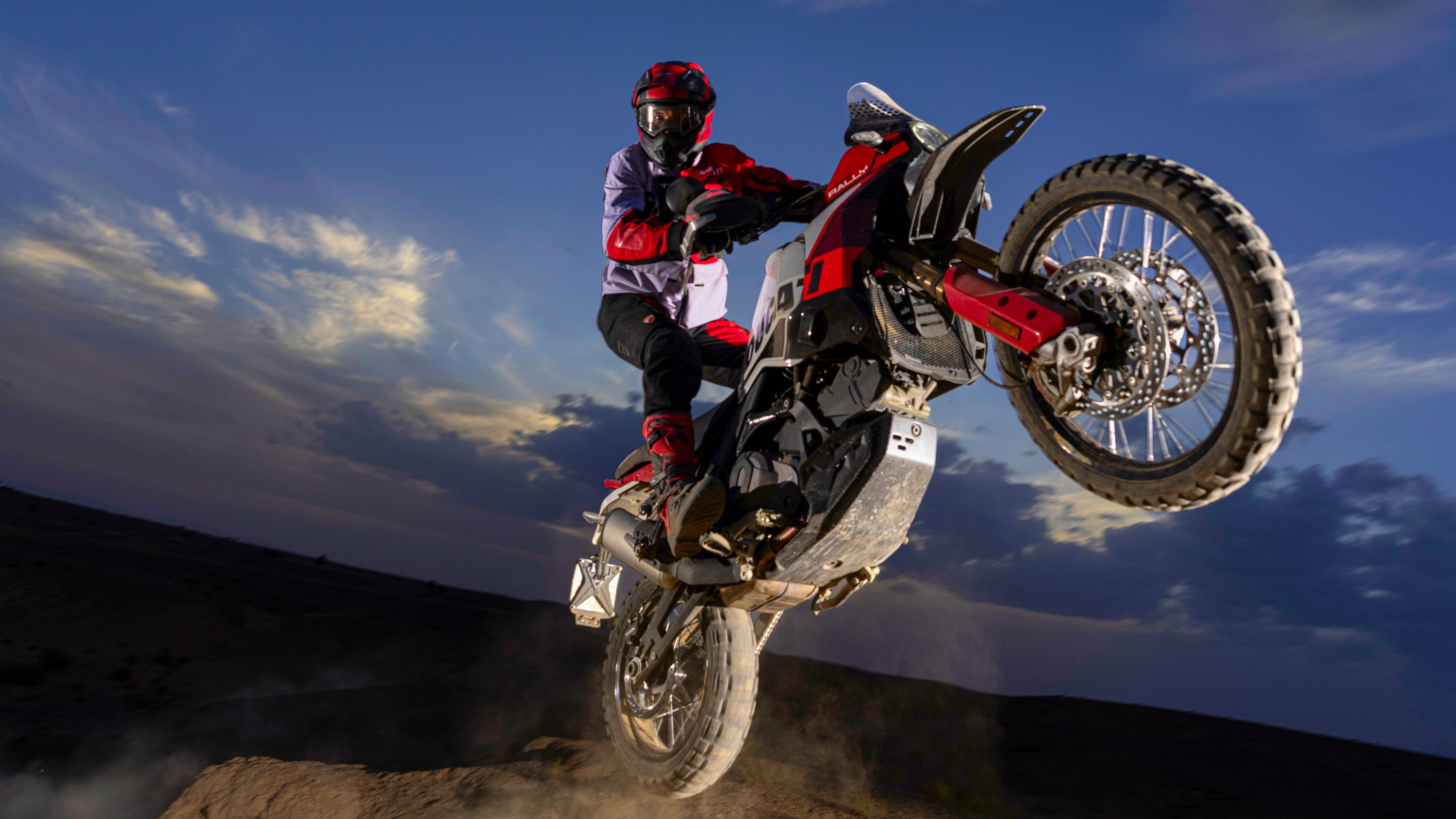 A motorcycle jumping over a rock in the desert